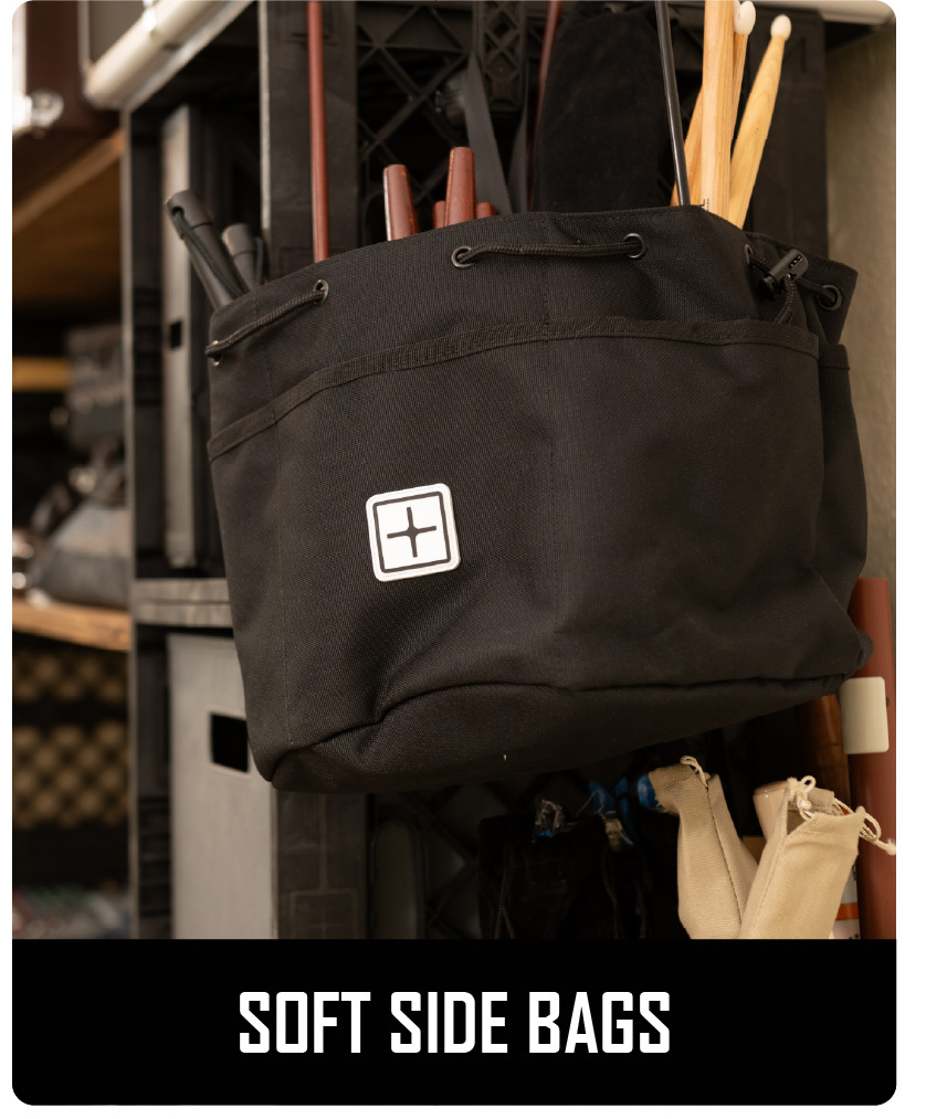 Black CratePlay™ soft side bag hanging from a modular crate setup and holding long tools or accessories.