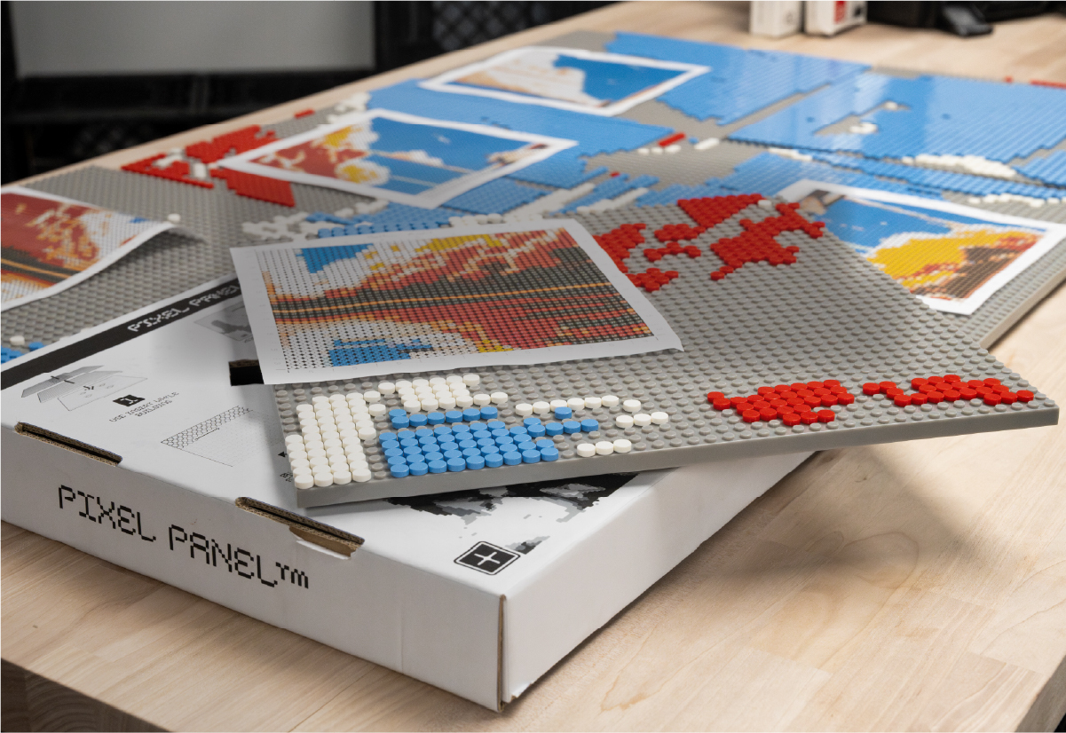 PixelPanel™ pixel art kit with colorful studs, printed art templates, and gray build plates.