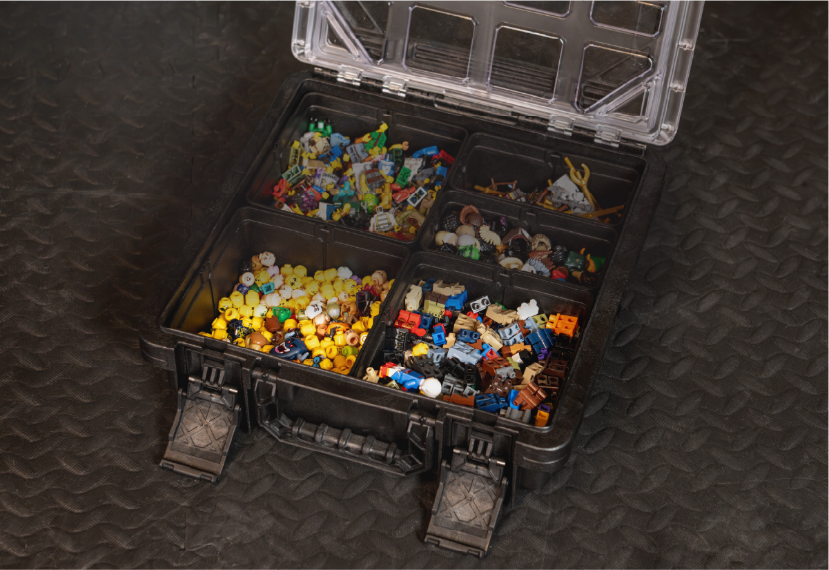 Open CratePlay™ BaseBox storage case filled with organized building bricks, minifigures, and small toy parts.