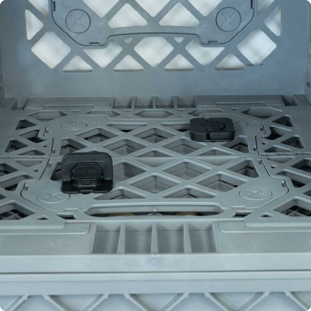 Close-up of black D-Ring Connectors installed inside a gray UbeCube crate to secure two crates together.