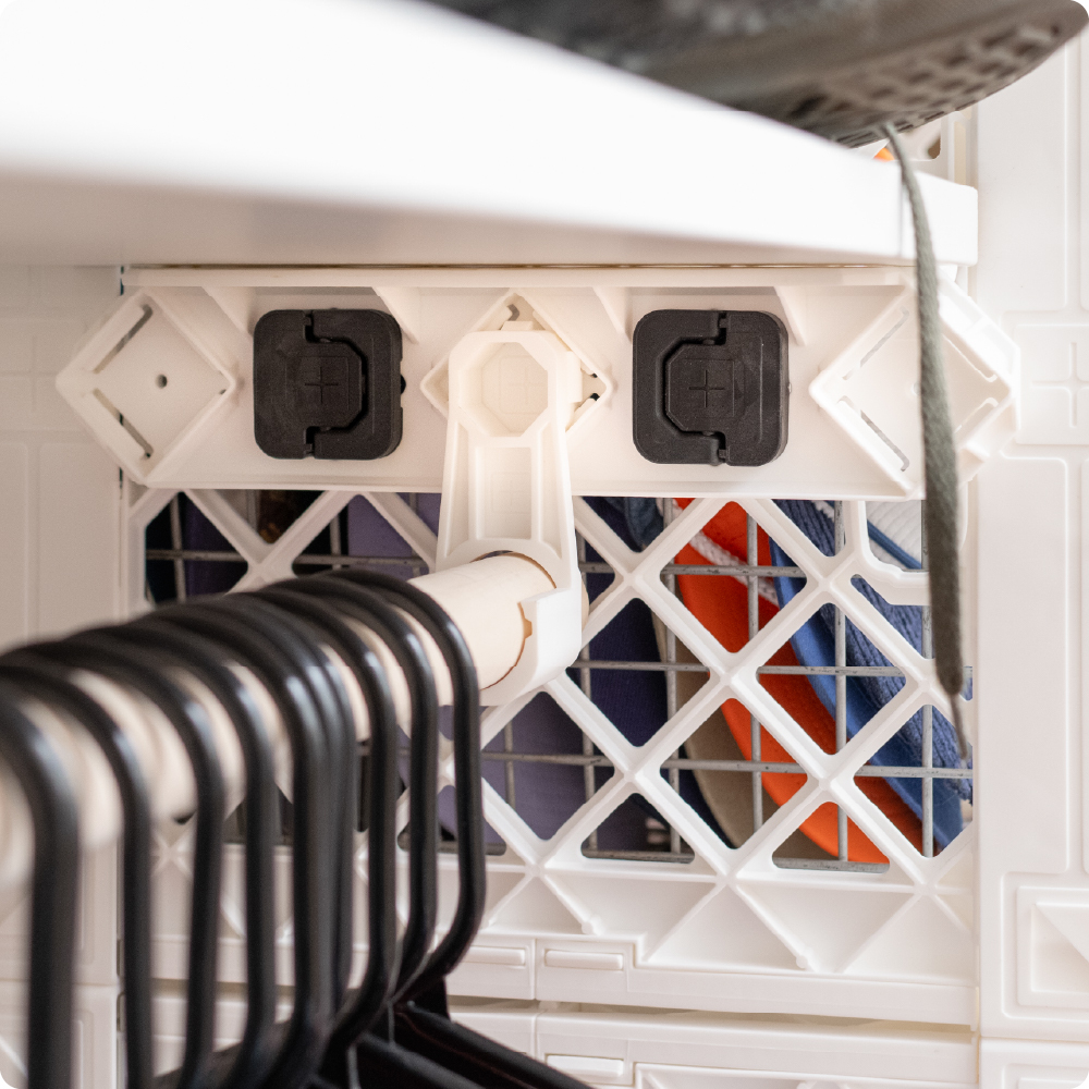 White UbeCube closet setup with D-Ring Connectors securing a ClosetStrip to the outside of a UC02 crate.