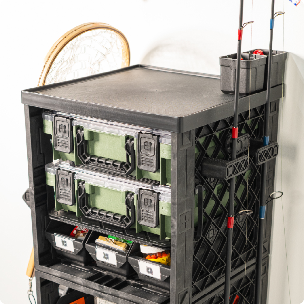 Black UbeCube fishing setup with a Seat Topper work surface, stacked BaseBoxes, Grab Bins, and side-mounted fishing rods.