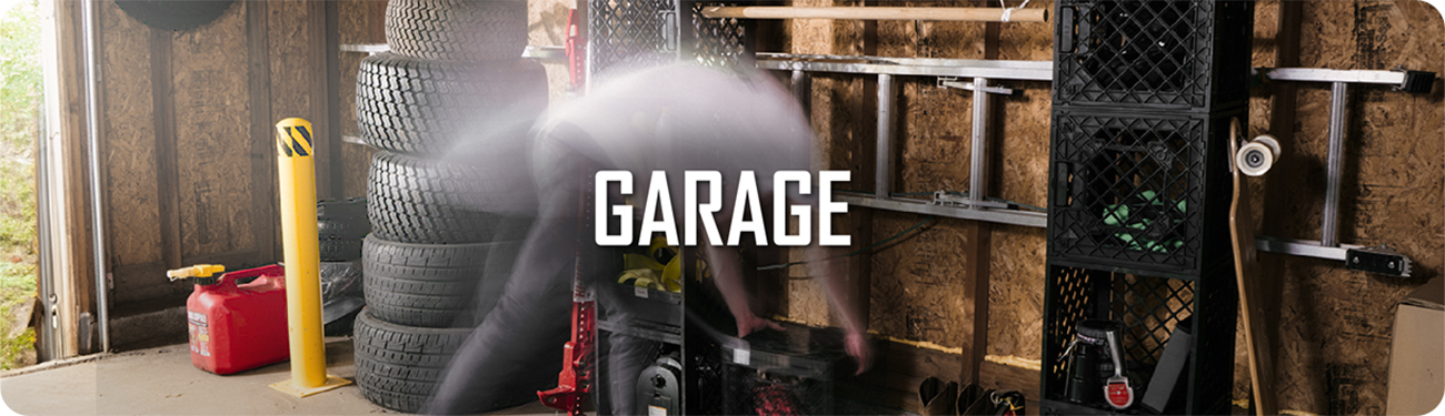 UbeCube storage system mounted in a garage with stacked tires, tools, and ladders, labeled ‘GARAGE’.