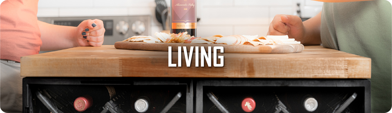 UbeCube modular storage crates used as a kitchen island base with wine bottles stored below and a charcuterie board labeled ‘LIVING’ on top.