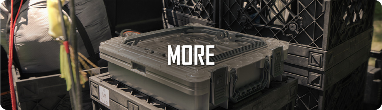 Stacked UbeCube crates and UbeCube utility boxes loaded with outdoor gear. Text on image reads “MORE.”