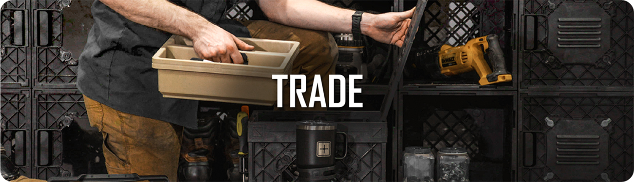 UbeCube modular storage crates used in a workshop setting, showing a worker organizing tools and trays labeled ‘TRADE’.
