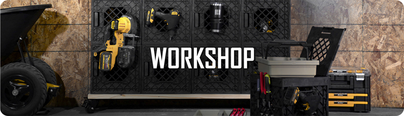 UbeCube modular workshop setup with stacked crates storing power tools and accessories against a plywood wall, labeled ‘WORKSHOP’.