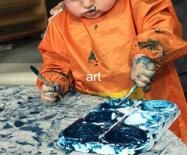 art - young child making a mess with paint