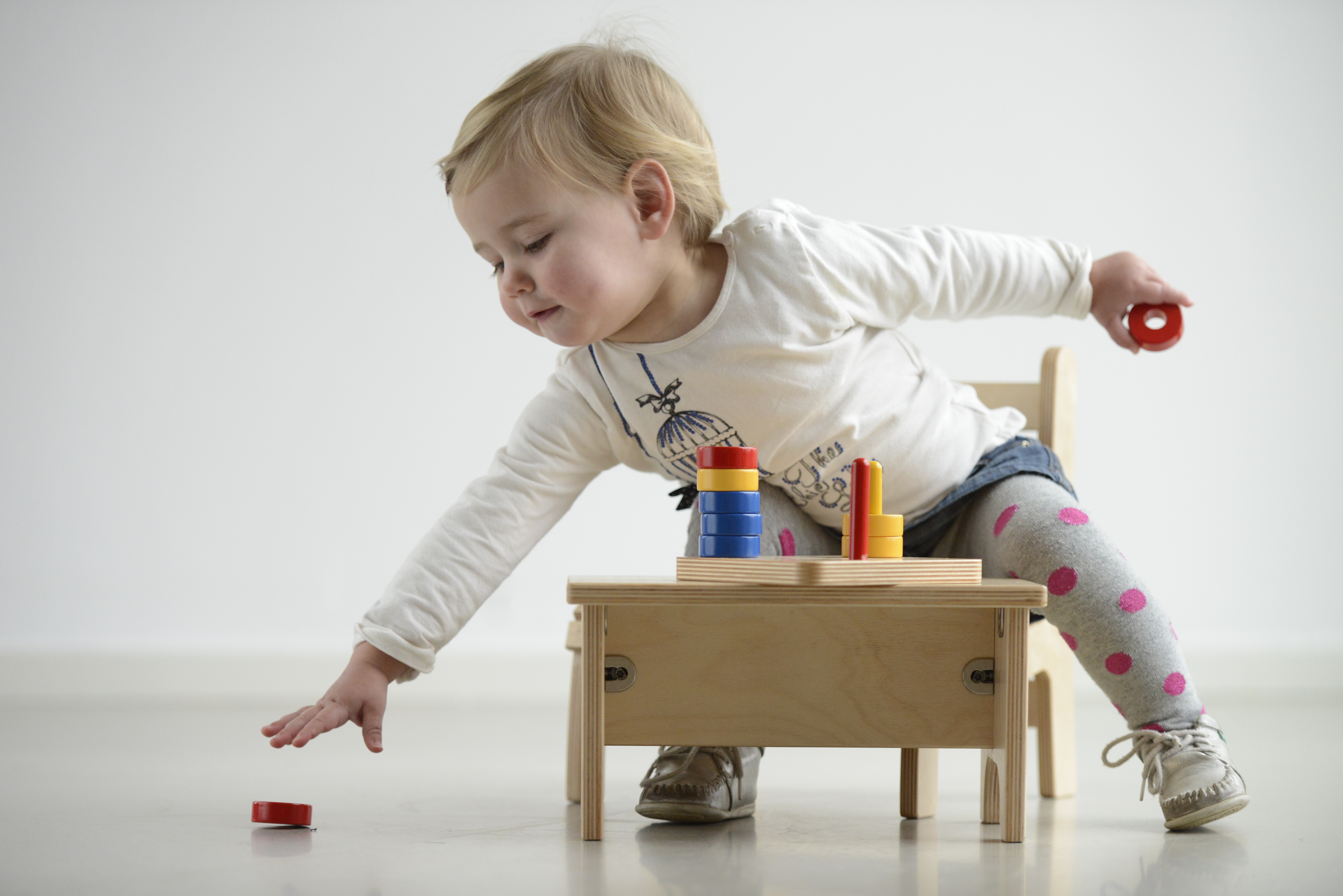 baby sitting playing with Nienhuis Montessori equipment