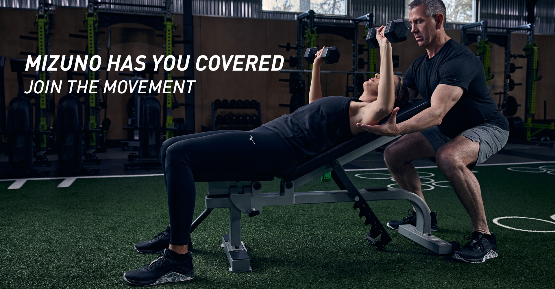 man being assisted with chest press