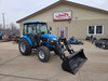 New LS MT357HC cab tractor with loader parked outside Koops dealership featuring 57HP diesel engine and enclosed heated and air-conditioned cab.