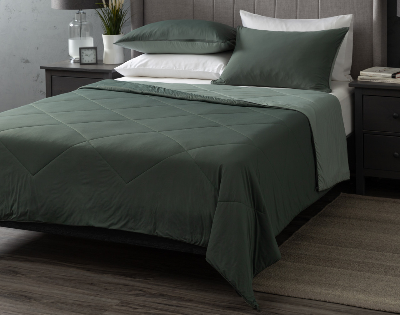 Our Balsam Cool Touch Blanket dressed over a white bed with coordinating pillowcases.