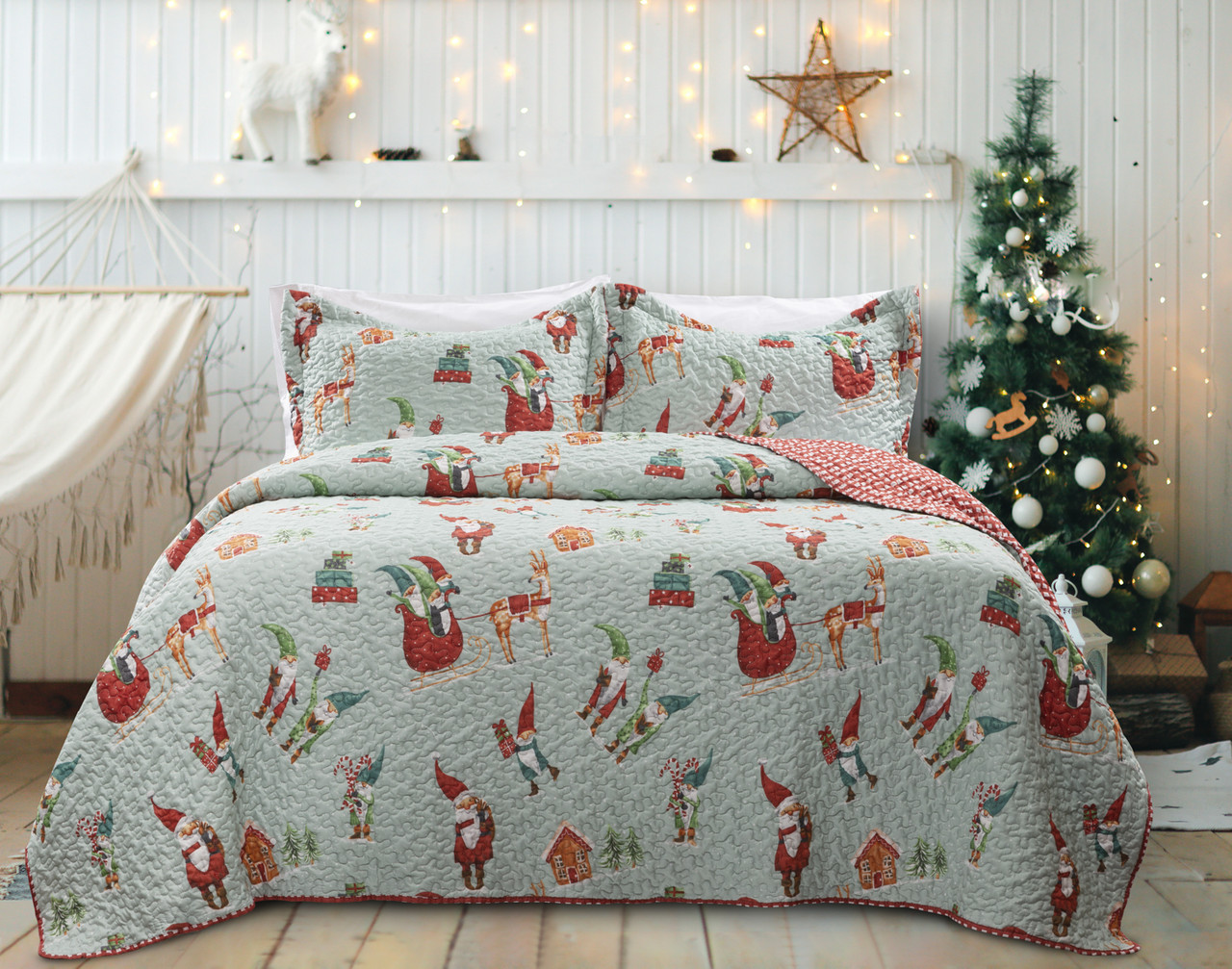 Our Santa's Elves Coverlet Set in a bright white bedroom, accessorized with seasonal wall decorations and a Christmas tree.