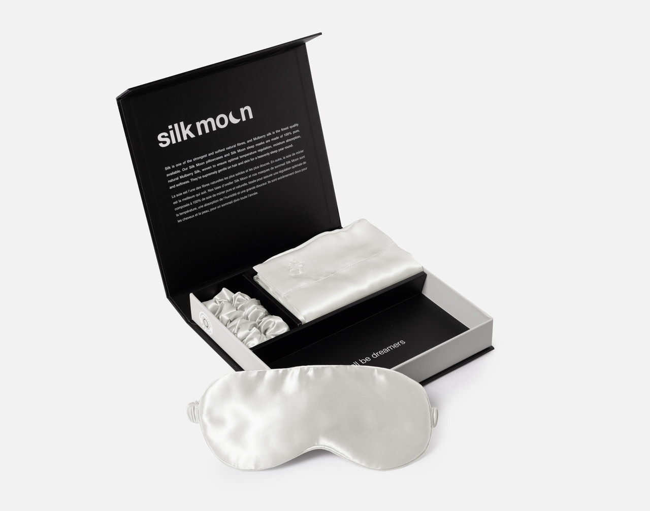 Angled view of our unboxed Mulberry Silk Gift Set in Snow featuring a silk eye mask, pillowcase, and scrunchie.