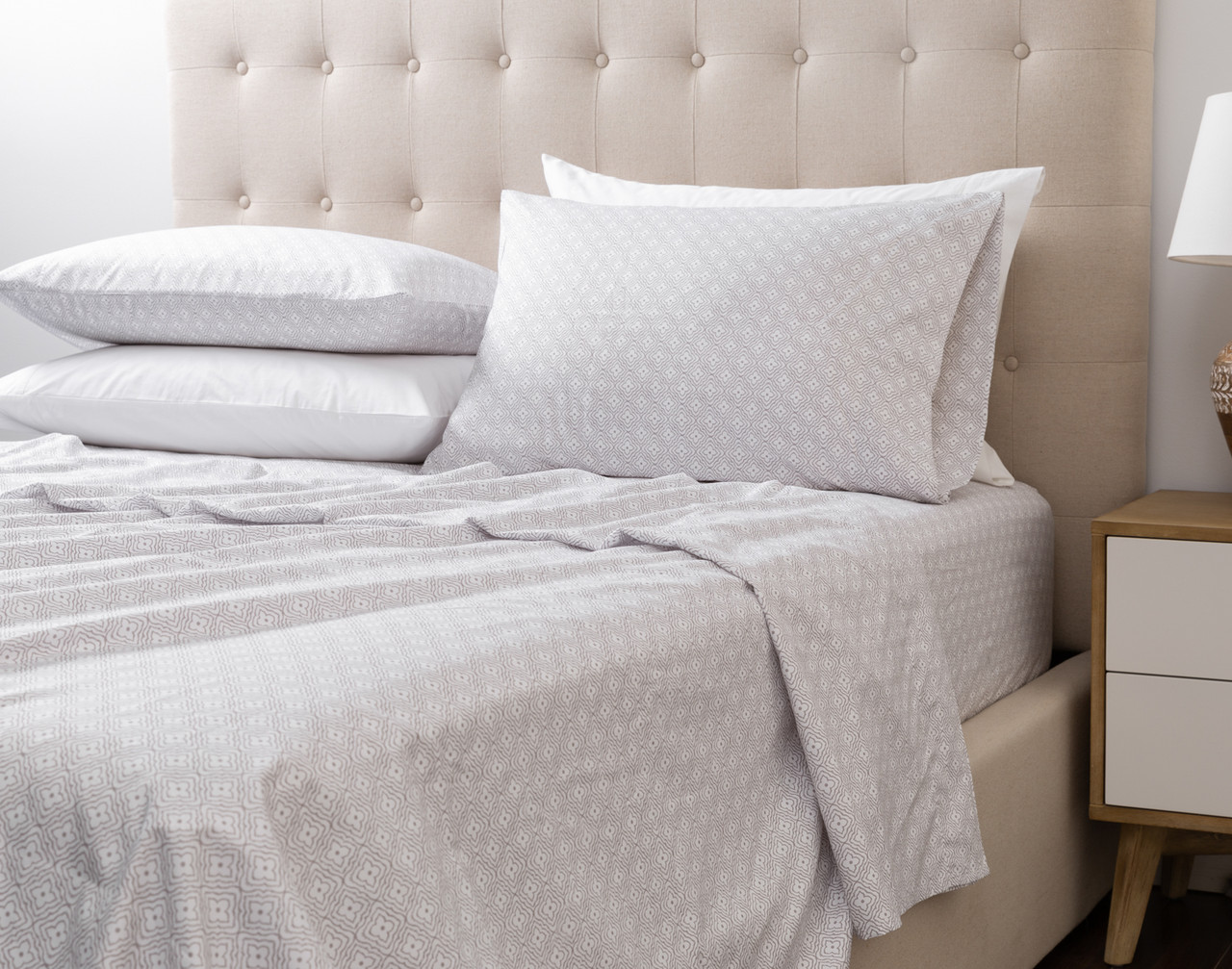 Our Recycled Microfiber Sheet Set in Chester dressed over an undecorated bed in a neutral bedroom.