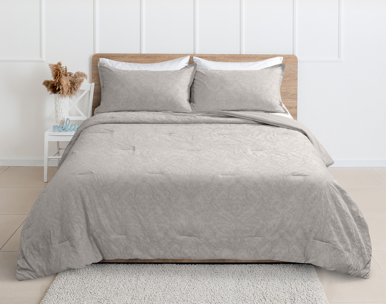Front view of our Cortina Cotton Matelassé Comforter Set in Sand dressed over a queen bed in a clean white bedroom.