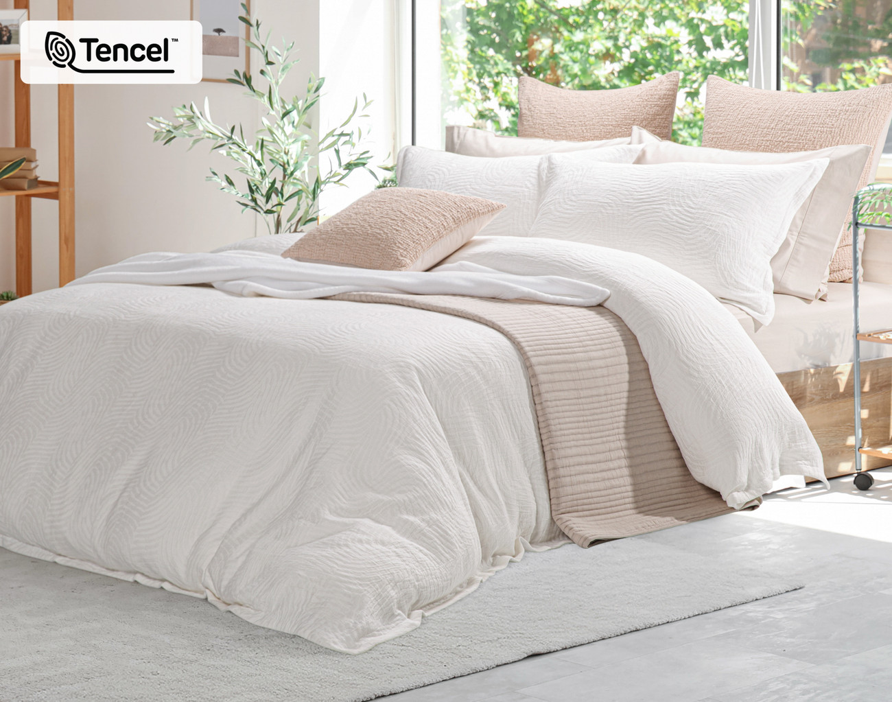 Angled side view of our Nuala Duvet Cover dressing a queen bed with matching accessories.
