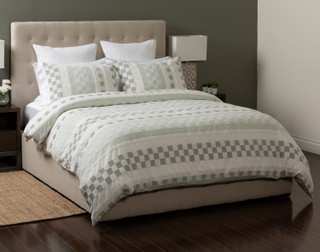 Side view of our Tazio collection, featuring the duvet cover and pillow shams with our Crinkle Euro Shams in white.