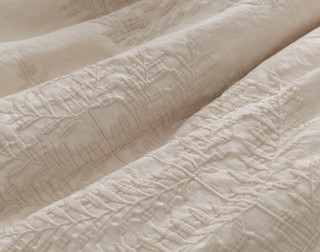 Close up of our Marcona Duvet Cover, showing its botanical jacquard surface.