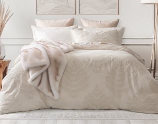 Front view of our Marcona Duvet Cover Set dressing a queen bed with matching accessories in an elegant bedroom.