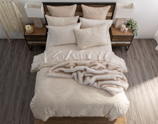 Top-down view of our Marcona Duvet Cover Set dressing a queen bed with matching accessories in a simple bedroom.