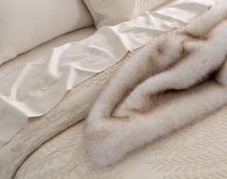 Close up on a bed dressed in our Marcona collection and matching accessories.