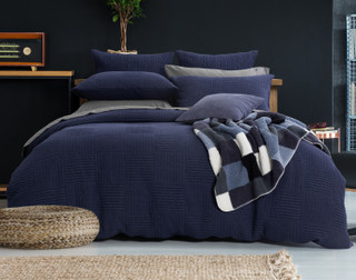 Our Kye Duvet Cover Set dressing a queen bed with matching accessories in an elegant room.
