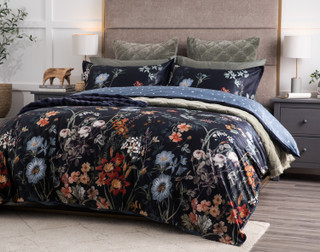 Angled view of our Sarita Duvet Cover dressed with our Bonsai Sheets and matching green quilt set.