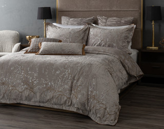 Angled view of our Luxembourg Velvet Duvet Cover dressing a queen bed with matching accessories.