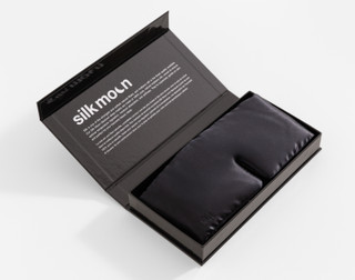 Our 100% Mulberry Silk Blackout Sleep Mask in Black in its Silk Moon box.