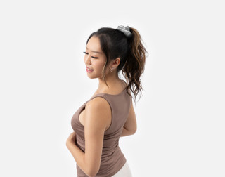 Woman turning her head while wearing our Silver Mulberry Silk Scrunchie to hold up her ponytail.