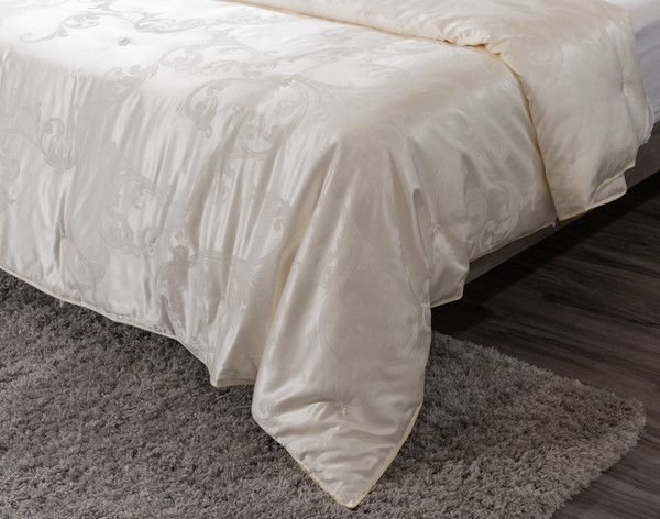 Angled view of the bottom corner on our Fortuna Mulberry Silk Duvet in a tall to show its gentle drape.