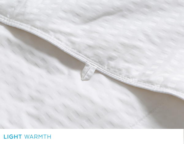 Close-up of the edge and duvet tie along the edge of our Petite Pearl Mulberry Silk Duvet.