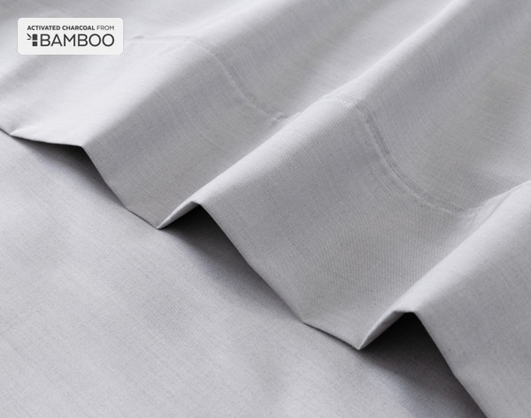 Flat sheet for our Bamboo Cotton Sheet Set with Activated Charcoal ruffled lightly over a matching smooth surface.