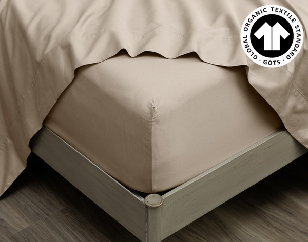 Close-up on the corner of our 300TC Organic Cotton Fitted Sheet in Stone wrapped around a mattress.