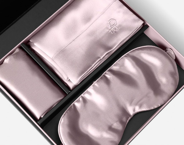 The silk pillowcase, eye mask, and delicates bag of our Mulberry Silk Gift Set in Lavender folded in its packaging.