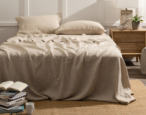 Front view of our Signature European Linen Flat Sheet in Natural dressed over a queen bed with matching sheeting.