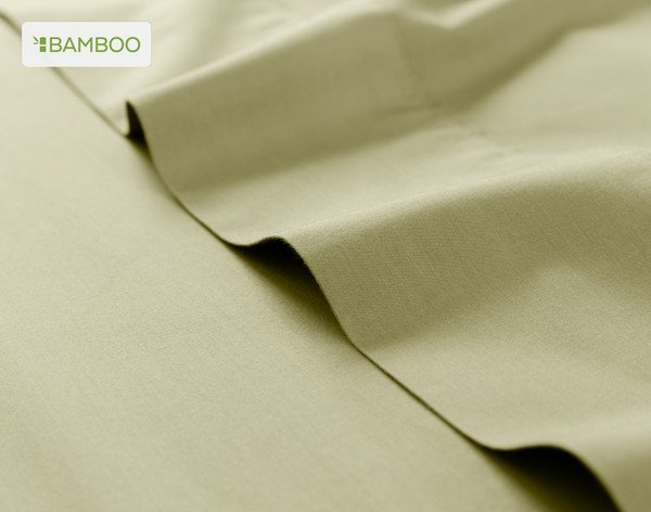 Flat sheet for our Bamboo Cotton Sheet Set in Elm Green ruffled lightly over a matching smooth surface.