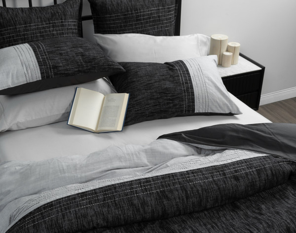 Angled view of our Tomas Duvet Cover to show the asymmetric styling in its pick-stitch lines.