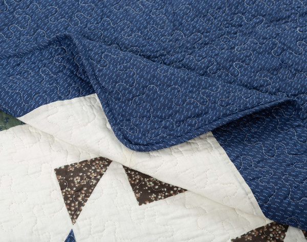 Folded corner on our Maureen Cotton Quilt Set to show its smooth curved edge.