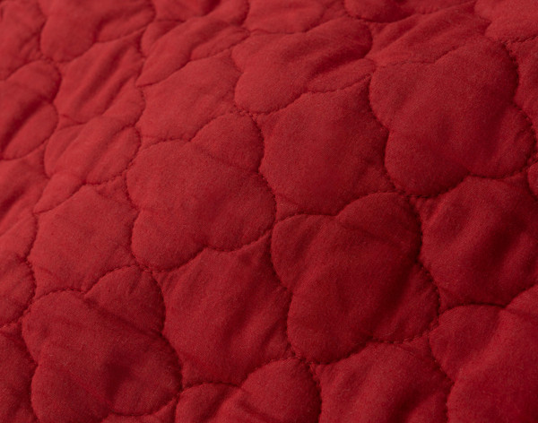 Close-up of the cotton backing on our Lattice Ruby Quilt Set to show its lighter diamond pattern.
