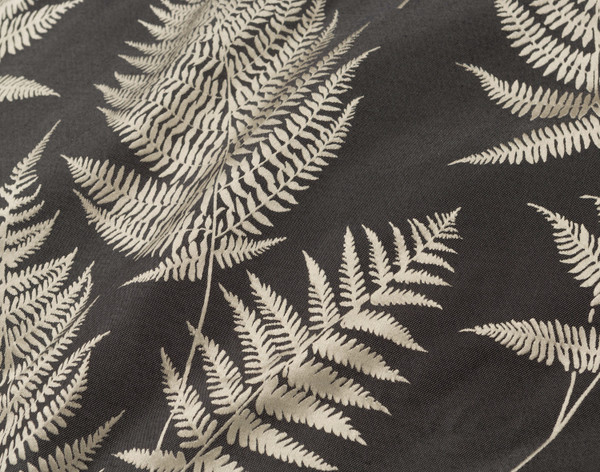 Close-up on our Nightfall Duvet Cover to show its detailed fern pattern and deep charcoal background.