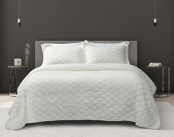 Our Cavell White Cotton Quilt Set dressed over a queen bed in a dark grey bedroom.