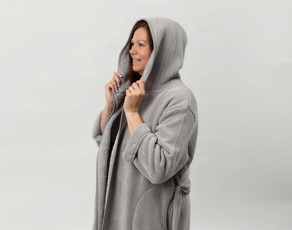 Closer view of woman wearing our Chenille Sherpa Bathrobe in Grey against a solid white background with hood raised over her head.