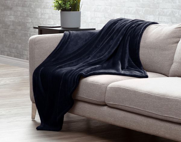 Our Midnight Blue Velvet Plush Throw draped over a couch.