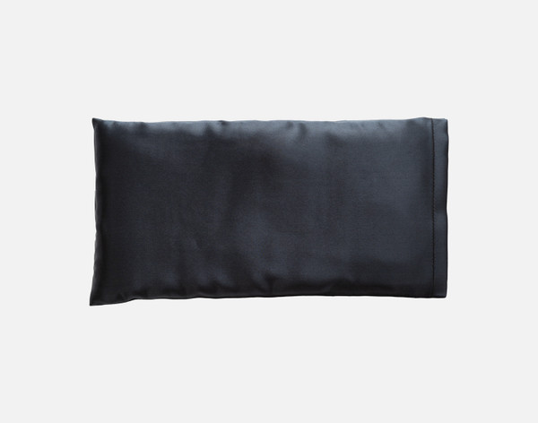 Front view of our Silk Eye Pillow in Black sitting against a solid white background.