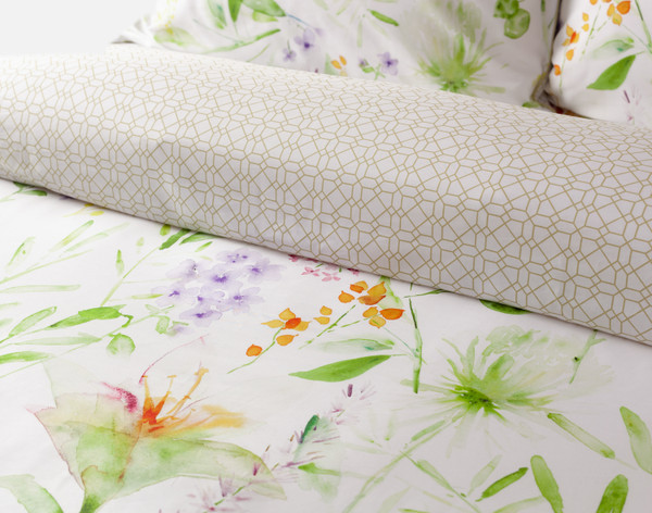 Folded top edge on our Faroe Duvet Cover to show its botanical surface and golden trellis reverse.