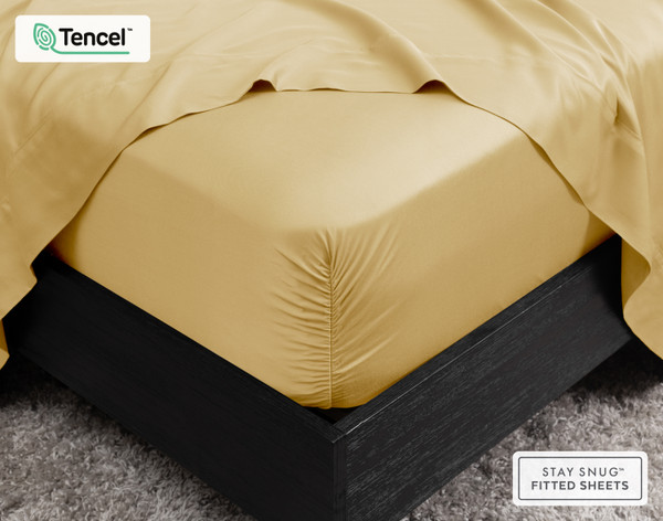 Corner view of our BeechBliss TENCEL™ Modal Fitted Sheet in Sun Shower on a white background over a mattress.