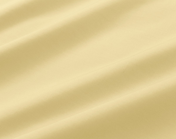 Gros plan sur le tissu de coton confortable de notre coton percalé drap ensemble  en jaune.