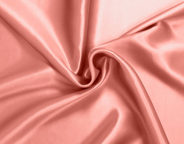 Furled up fabric on our Mulberry Silk Pillowcase in Flamingo to show its luxuriously smooth surface.